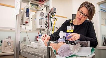 Nurse working with infant Mannikin